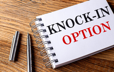 KNOCK-IN OPTION text on notebook with pen on the wooden background