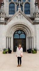 woman standing in front of church