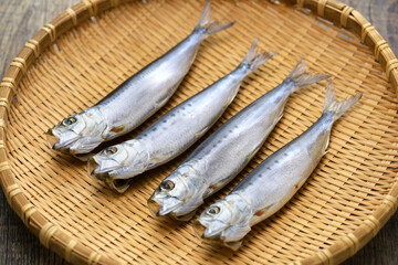 Iwashi marubosi ( semi-dried Japanese sardines ) isolated on a bamboo tray.