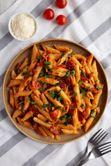 Homemade One-Pot Creamy Tuscan Pasta on a Plate, top view. Flat lay, overhead, from above.
