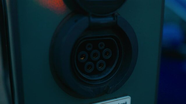 Close up of a cars electric blue charging port, symbol of automotive evolution