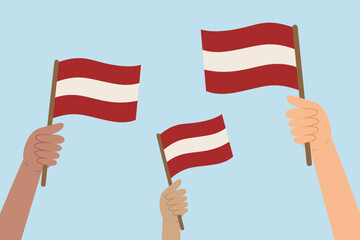 Diverse hands holding flags of Latvia. Vector illustration of Latvian flags in flat style on blue background.
