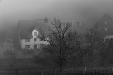 Houses in an ancient city shrouded in fog