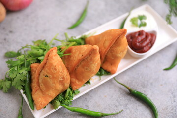 Samosa Indian famous street food snack closeup with selective focus and blur