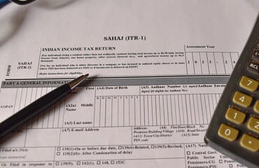 A closeup picture of ITR 1 forms on a table with a black pen on it.