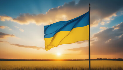 Ukrainian flag in a wheat field against the sunset sky