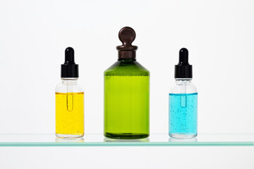 Dropper bottles close-up. Colorful facial serum, essential oil on a white background. Beauty...