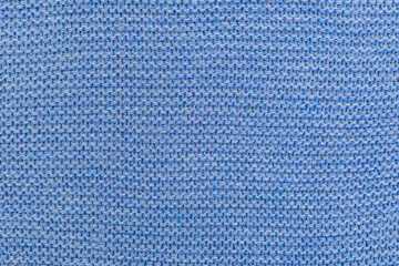 light blue garter stitch fabric knitted from wool close-up background.