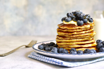 Stack of fresh hot pancakes with maple syrup and blueberries. - 760778934