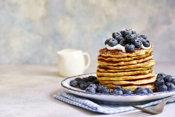 Stack of fresh hot pancakes with maple syrup and blueberries. - 760779171