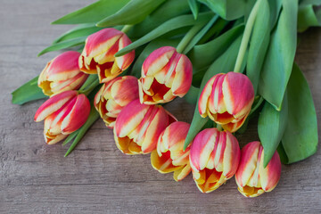 A bouquet of yellow and pink tulips.