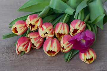 A bouquet of yellow and pink tulips.