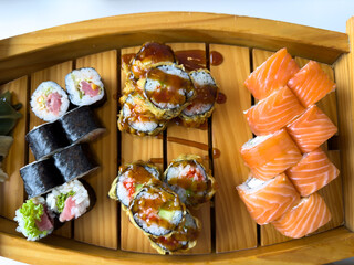 Rolls with red fish on a wooden tray