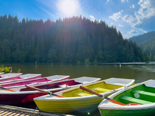 Colorful boats at the pier on a mountain lake