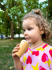 Beautiful curly girl eating ice cream