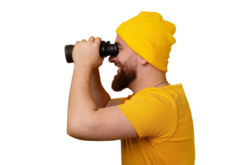 smiling man standing in profile and looking into binoculars isolated on transparent background