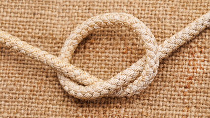 One brown sea knot on burlap. - 760796938