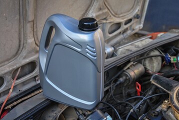 plastic canister with engine oil. Changing the engine oil of an old car. plastic container with motor oil.