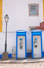 Bright blue phone cabin in the mediterranean