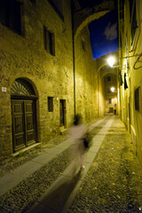 narrow street in the old town, Alghero, at night through the streets of the center. Sardinia, Italy