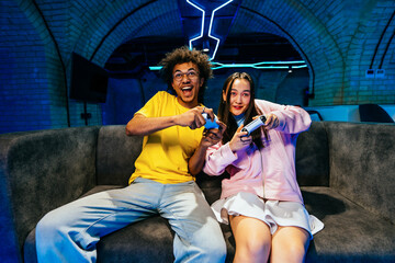 Multiethnic group of young friends playing videogames at home © oneinchpunch