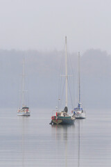 Fototapeta premium Boats in front of the shore of Cowichan Bay during a winter season on Vancouver Island in British Columbia, Canada