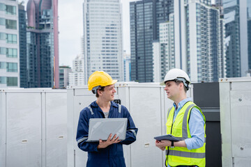 A group of engineers is inspecting the air conditioning cooling system of a large building or...