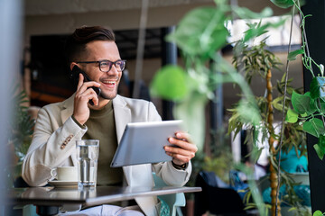 A successful businessman communicating with business partners on the phone.