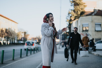 A young businessman laden with shopping bags confronting his girlfriend who is engaged in a phone...