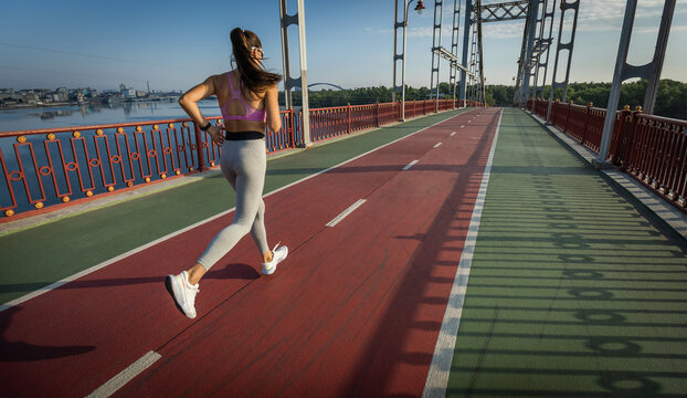 Sports background. The woman with a runner on the street be running for exercise.