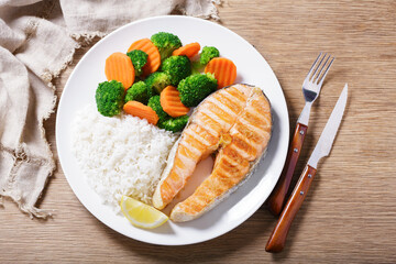 plate of grilled salmon, rice and vegetables, top view - 760815544