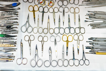 Set of many different scissors for manicure. Metal scissors on a white background. Close-up