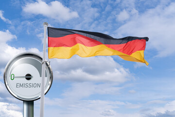 German flag flutters on the background of Gauge with inscription EMISSION. Arrow points to zero