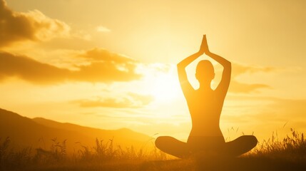 Person in yoga meditation pose in a serene field against a stunning sunset