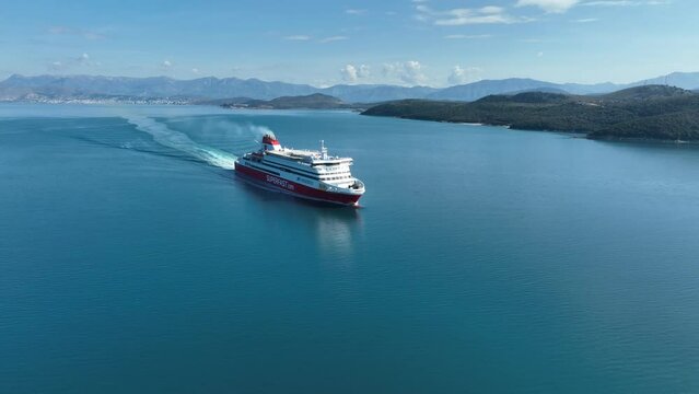 Aerial  Drone view of superfast xi cruise - passenger ship sails in corfu island Greece 