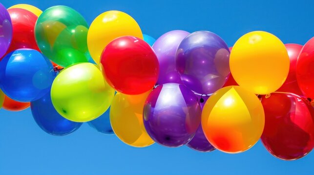 a bunch of balloons floating in the air with a blue sky in the backgrounnd of the image.