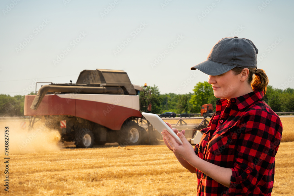 Aufkleber farmer with digital tablet on a background of harvester. smart farming concept.