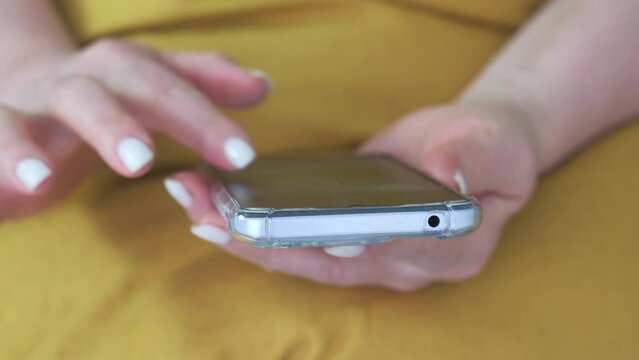  Woman is sitting on a sofa and online shopping.