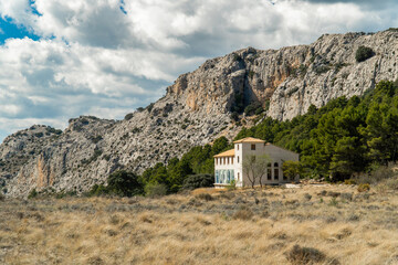 Isolated country house on mountains, on a cloudy day 