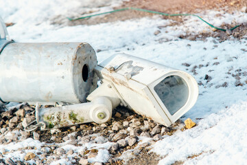 Damaged surveillance camera on the ground as a concept of failing policy of total surveillance....