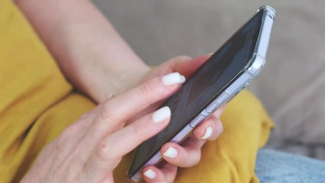  Woman is sitting on a sofa and online shopping.