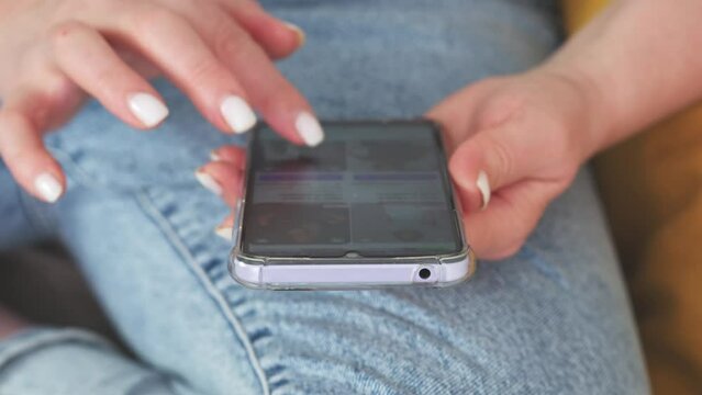  Woman is sitting on a sofa and online shopping.