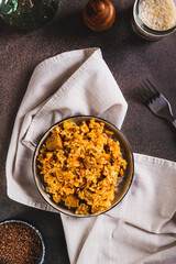 Traditional spicy pilaf with rice and meat on a plate on the table top and vertical view