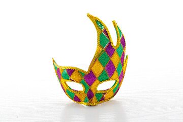 Beautiful multicolor carnival mask on a white background. Purim, Mardi Gras holiday concept.