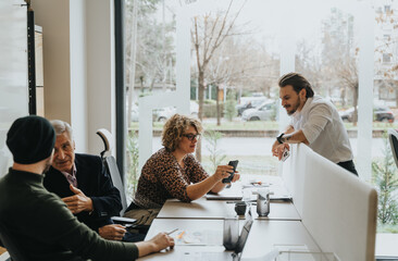 A different aged group of enthusiastic coworkers collaborating on tasks and discussing business strategies in an innovative workplace.
