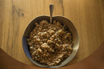Healthy food - buckwheat without additives. A simple healthy dish in a plate with a spoon stands on...