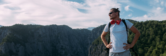 A male traveler stands at a terrible cliff in the canyon.