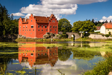 The Cervena (Red) Lhota Chateau is a beautiful and unique example of Renaissance architecture. It is located in the South Bohemian Region of the Czech Republic, surrounded by a picturesque lake. - 760847961