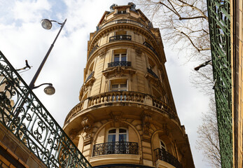 The facade of traditional French house with typical balconies and windows. Paris. - 760849554