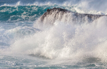 Ocean waves crushing against rocks